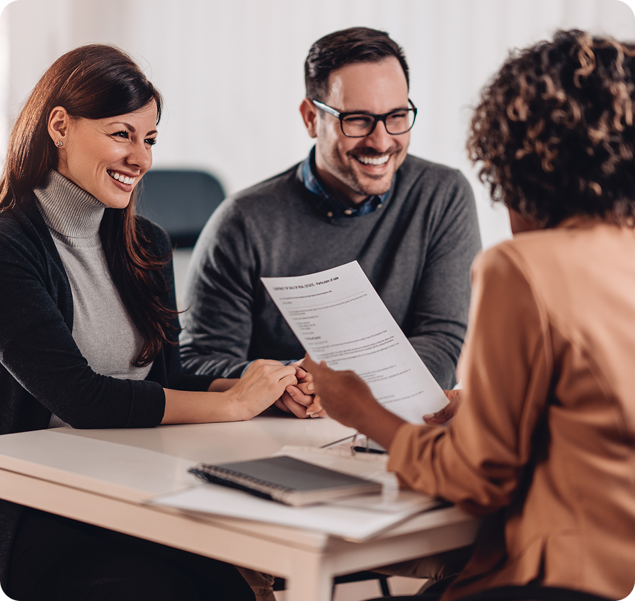Couple discussing document with a professional.